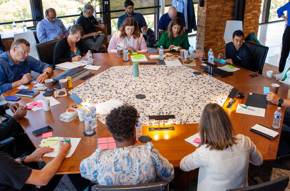 Innovation as a Service - team of people seated around a round table during an ideation session